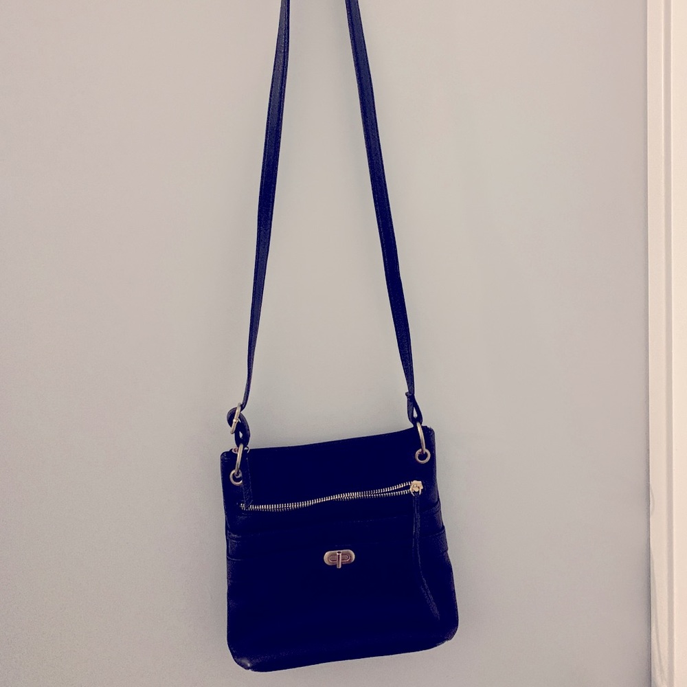 Black crossbody purse with a lot of storage for size